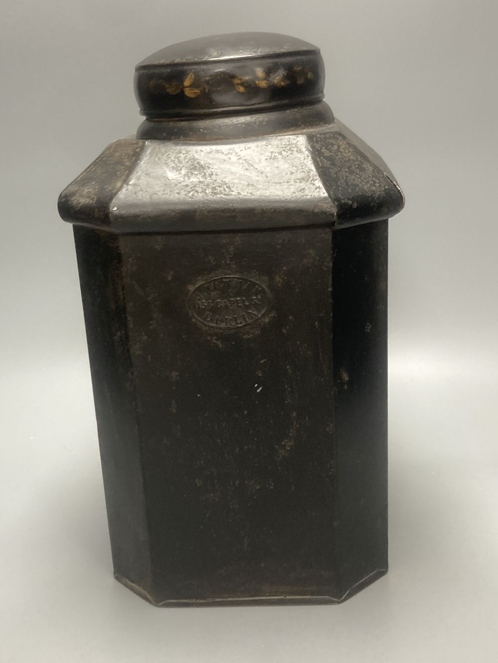 A 19th century toleware octagonal tea canister, J. Newman, Dublin, painted with flowers and Chinese script, 36cm